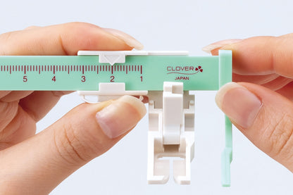 Clover sliding stitch guide presser foot with alignment ruler
