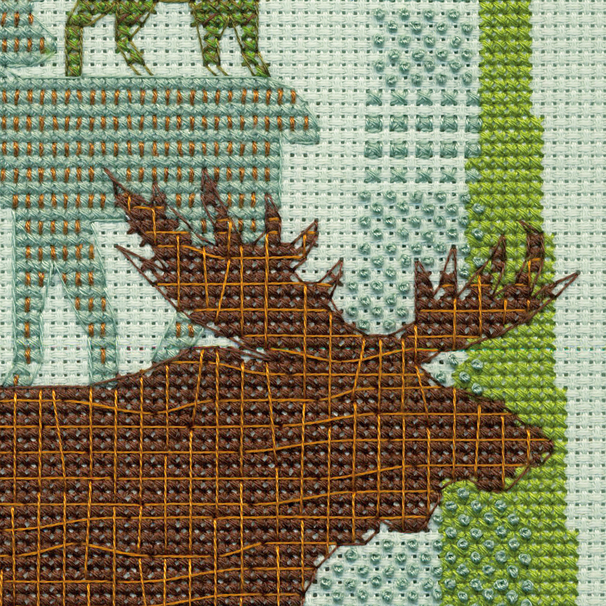 Finished Forest Folklore cross stitch of stacked woodland animals