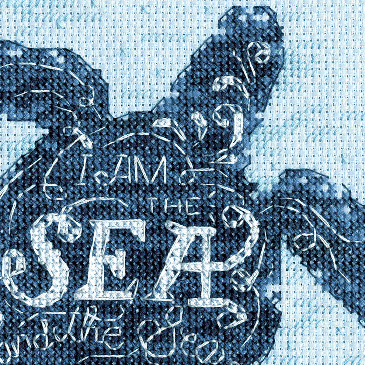 Finished sea turtle cross stitch on blue fabric