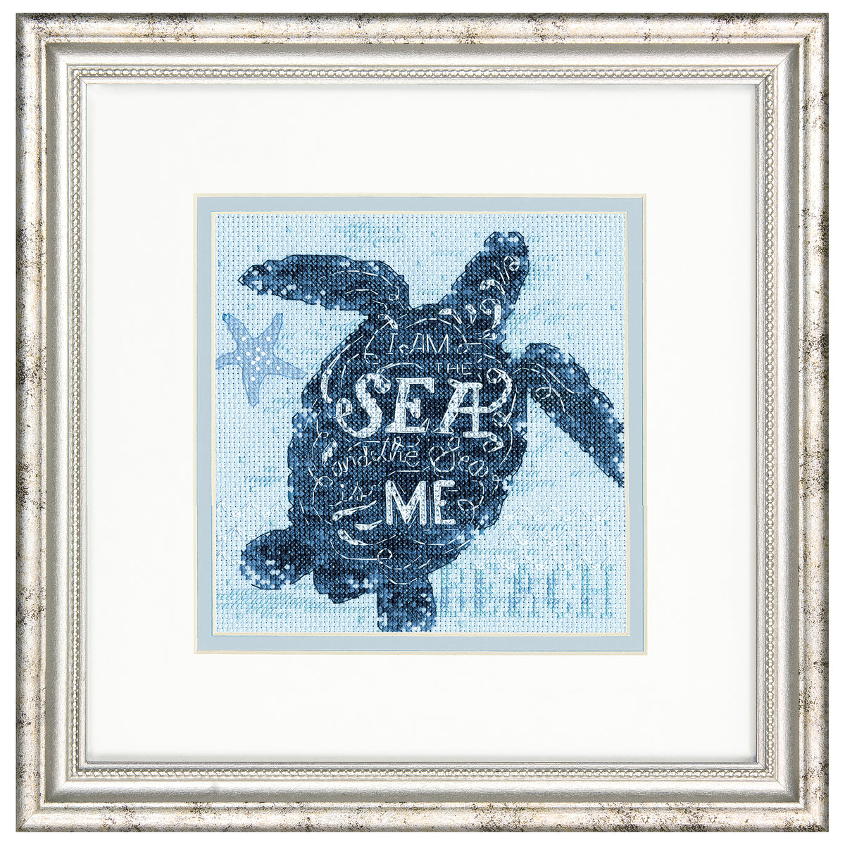 Finished sea turtle cross stitch on blue fabric