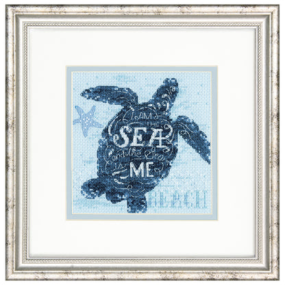 Finished sea turtle cross stitch on blue fabric