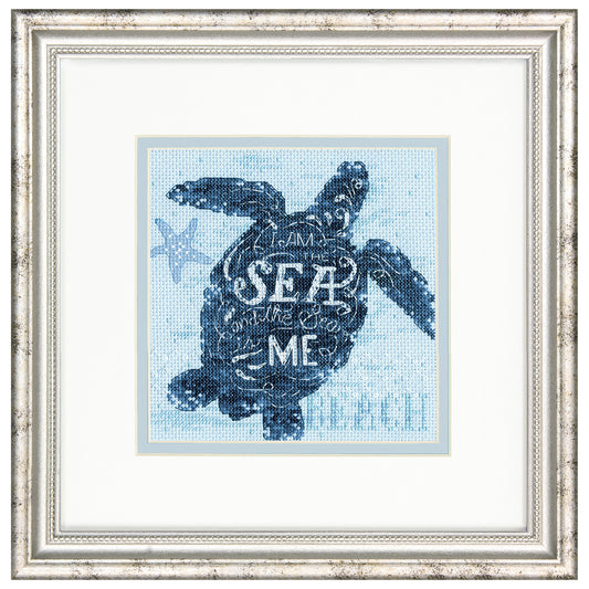 Finished sea turtle cross stitch on blue fabric