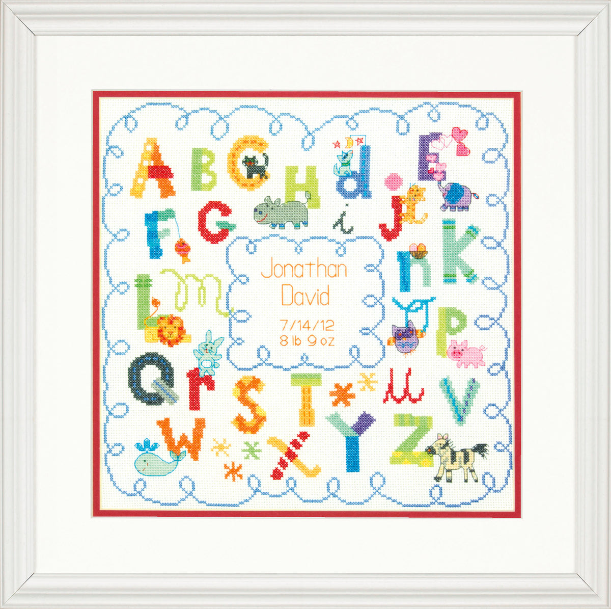 Alphabet birth record cross stitch kit with stitched letters and baby details