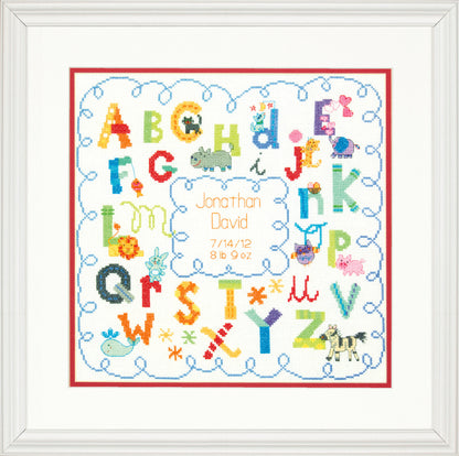 Alphabet birth record cross stitch kit with stitched letters and baby details