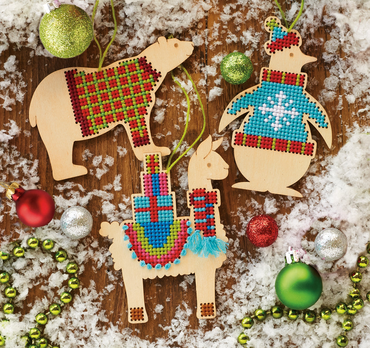 Three wooden animal shaped cross stitch ornaments
