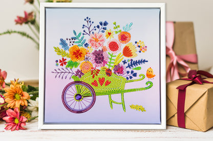 Diamond painting design of a wheelbarrow filled with colourful flowers