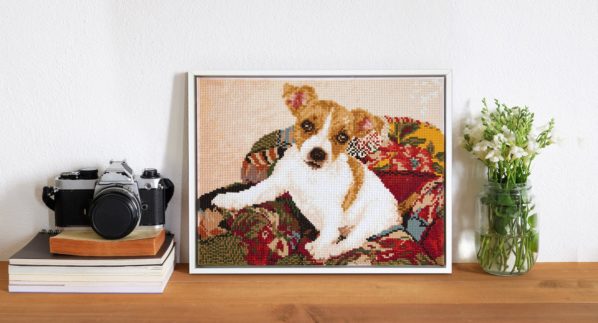 Diamond painting design of a puppy on a patchwork quilt