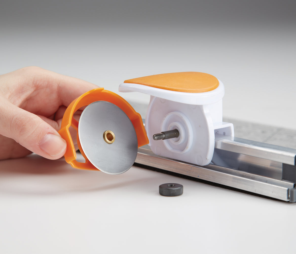Fiskars rotary cutter attached to a long acrylic ruler
