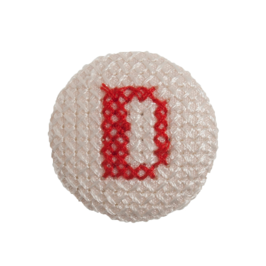 Round button with a red cross-stitch letter D