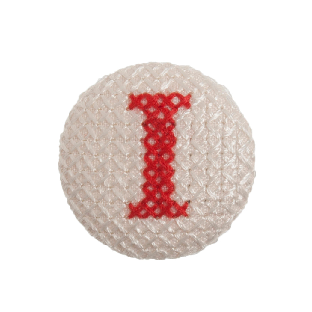 Round button with a red cross-stitch letter I
