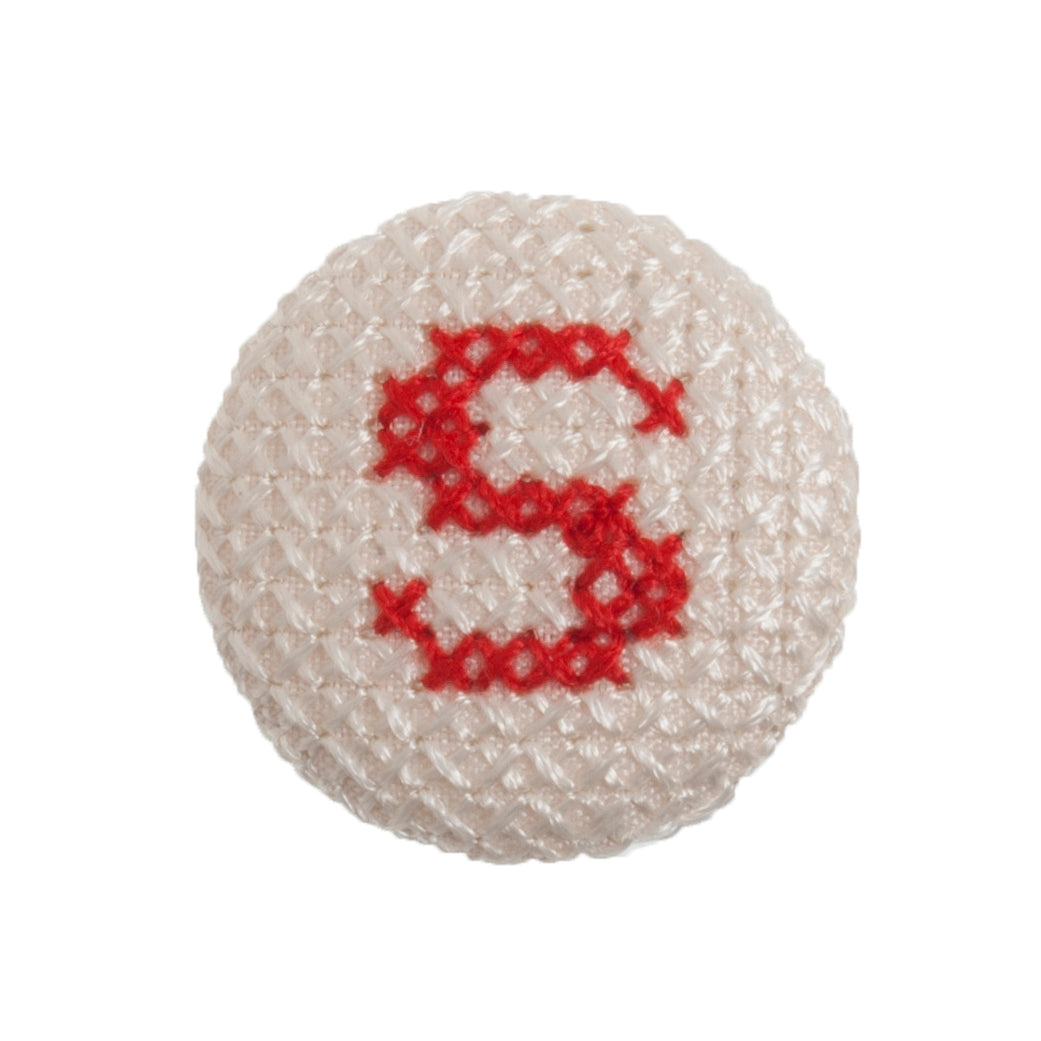 Round button with a red cross-stitch letter S