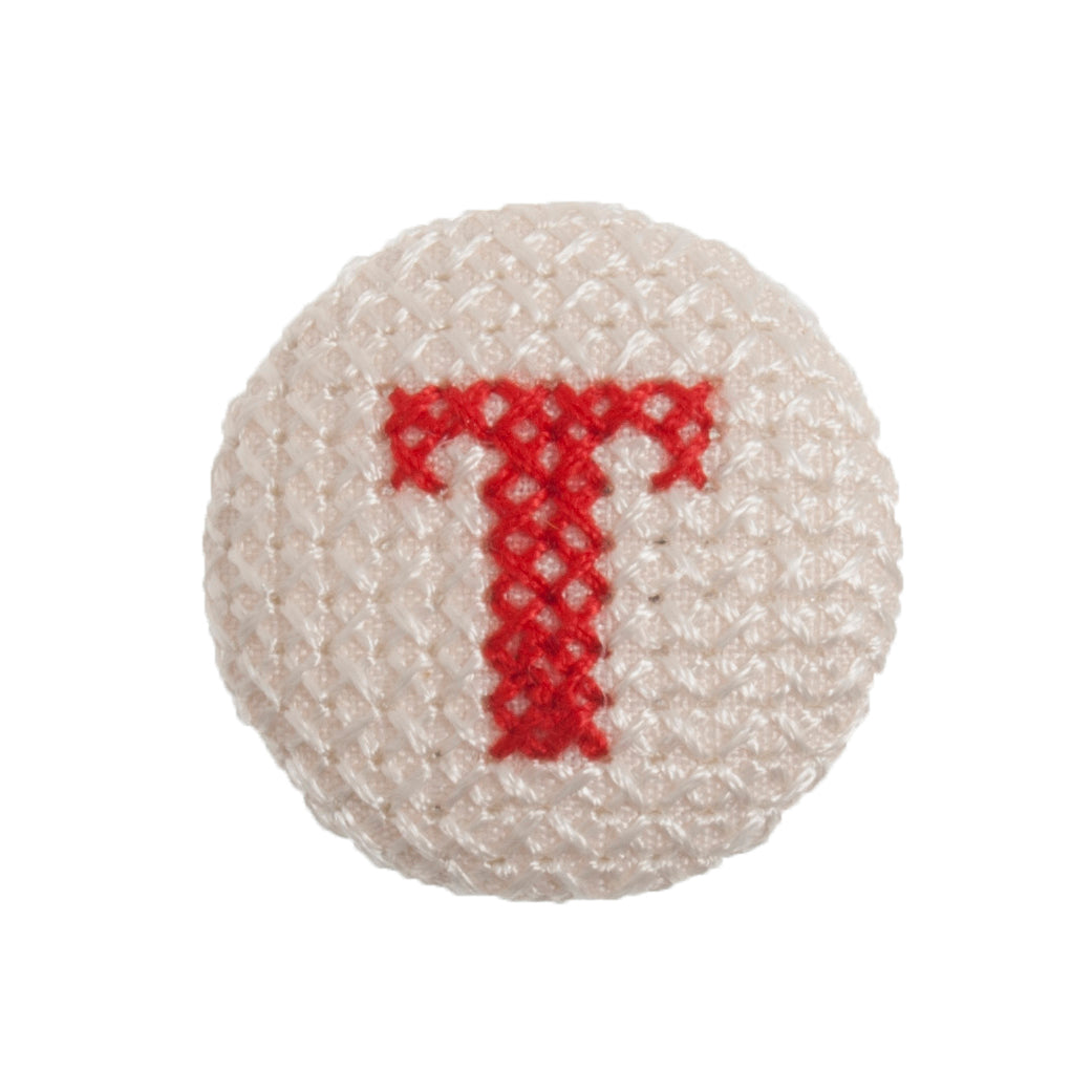 Round button with a red cross-stitch letter T