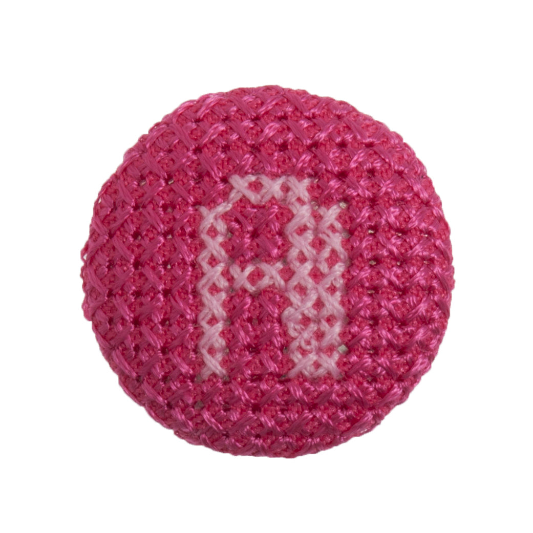 Round button with a fuchsia cross stitch letter A