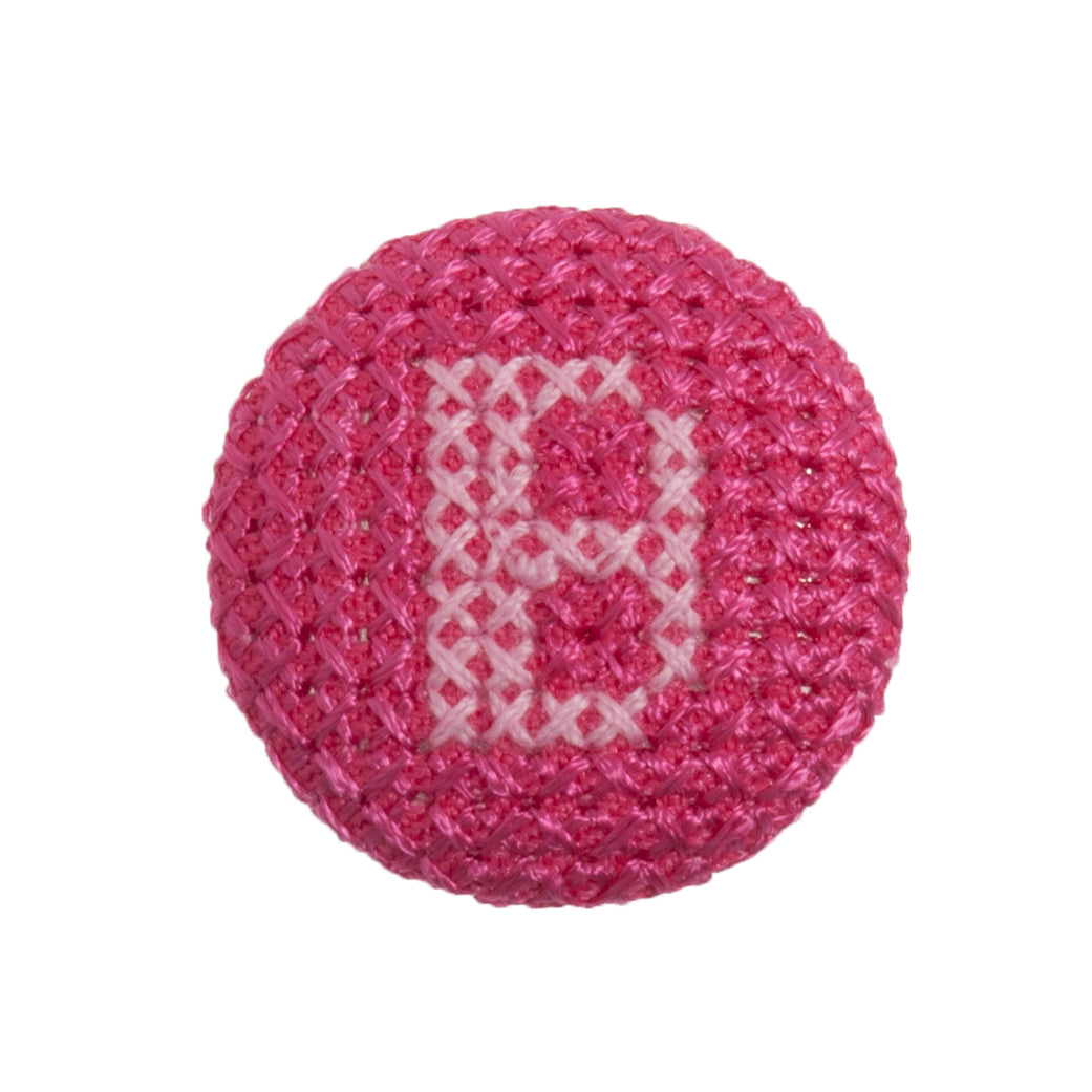Round button with a fuchsia cross stitch letter B