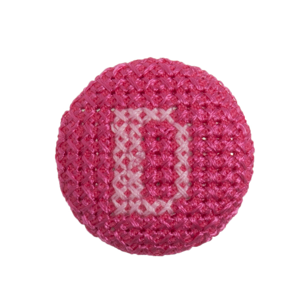 Round button with a fuchsia cross stitch letter D