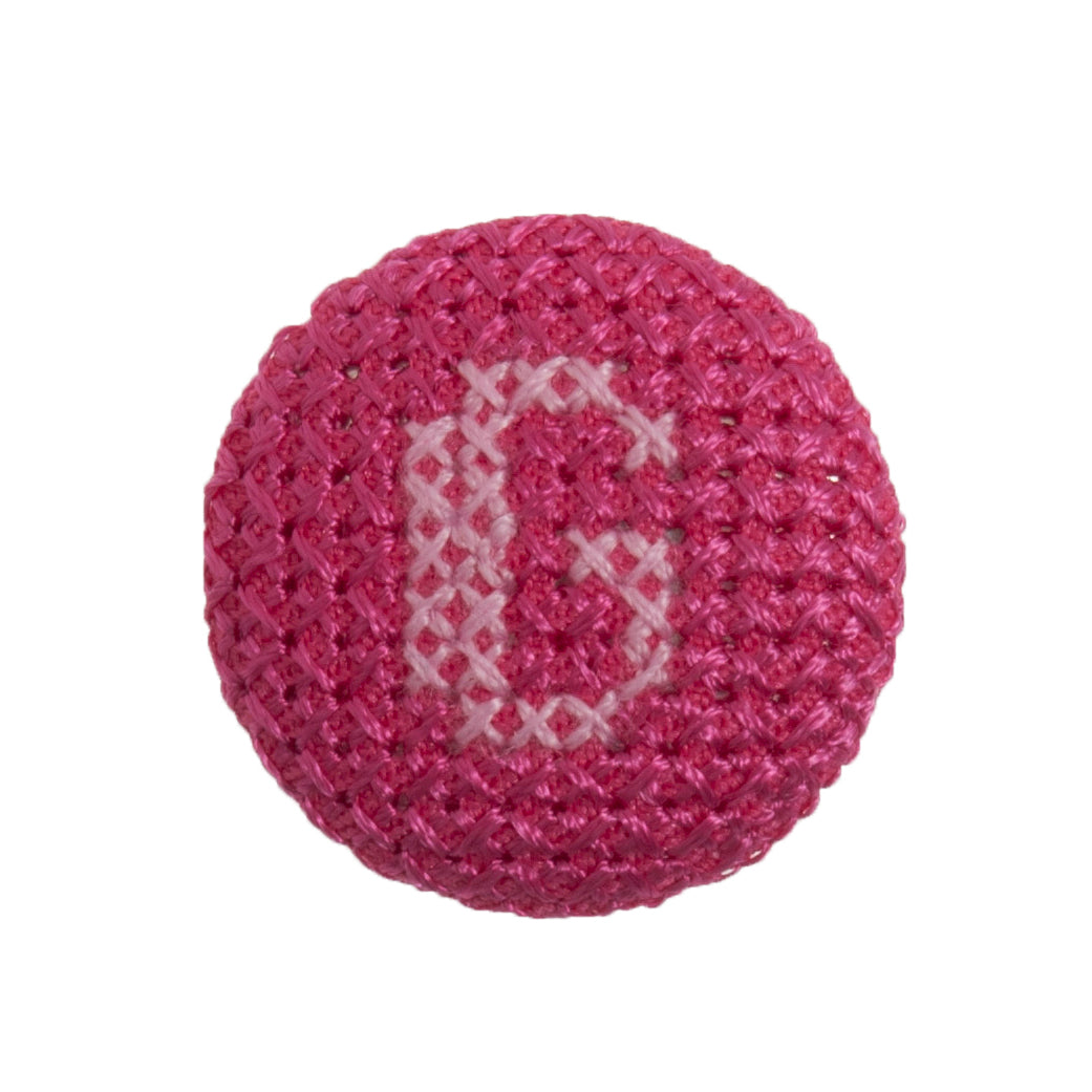 Round button with a fuchsia cross stitch letter G