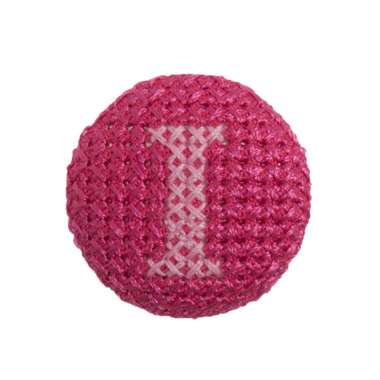 Round button with a fuchsia cross stitch letter I