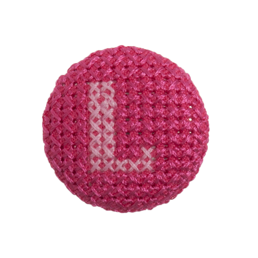 Round button with a fuchsia cross stitch letter L