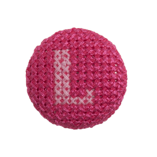 Round button with a fuchsia cross stitch letter L
