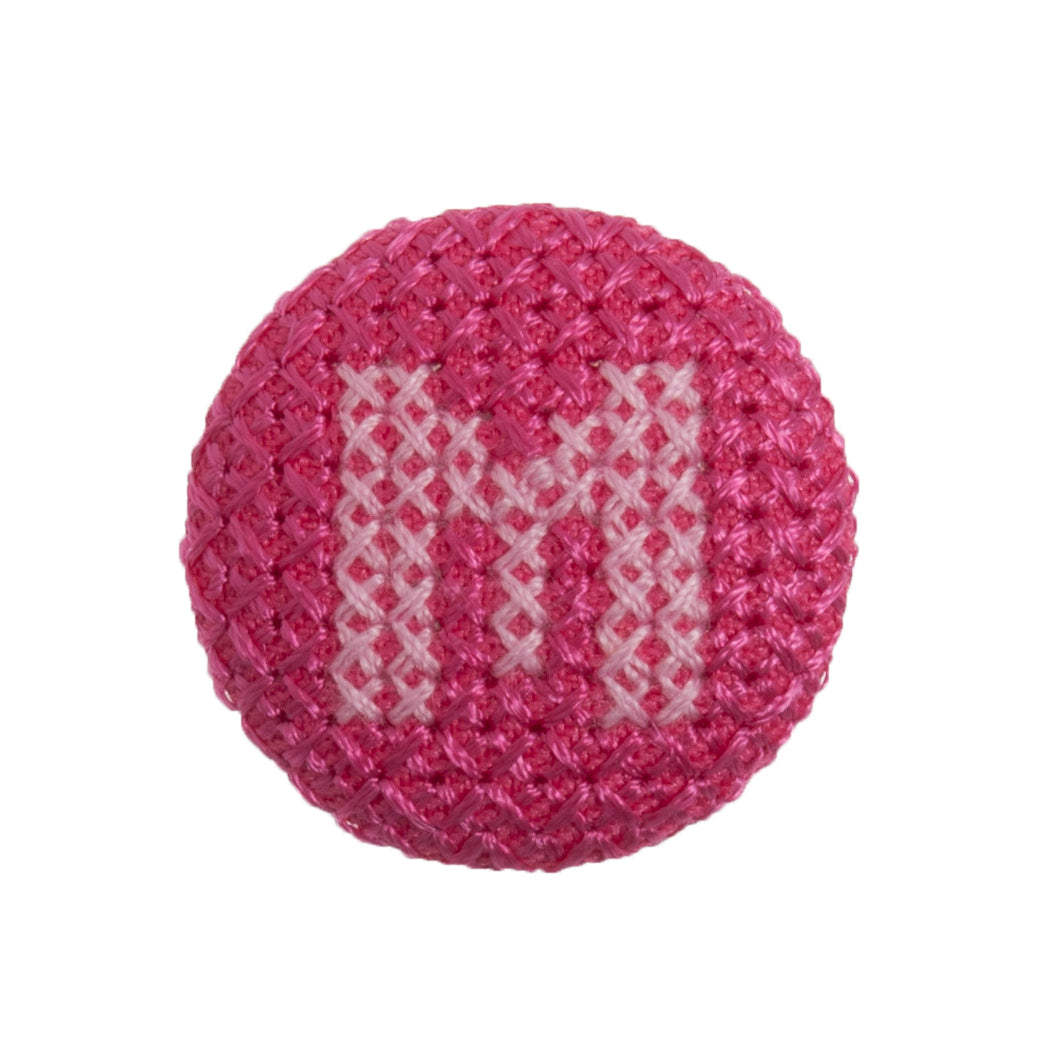 Round button with a fuchsia cross stitch letter M