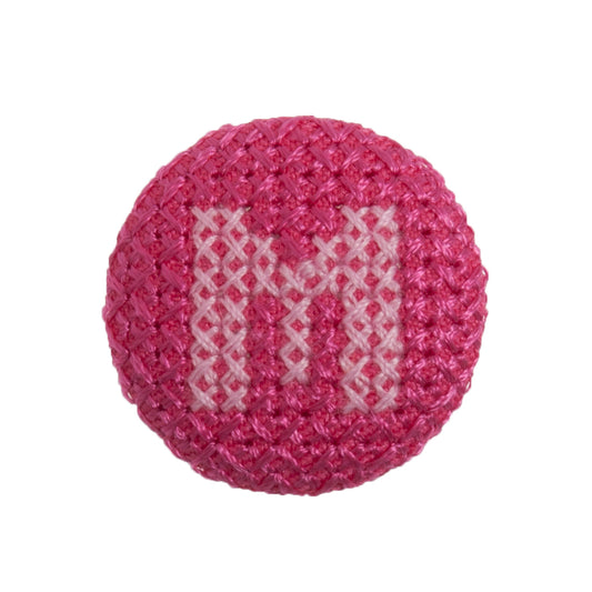 Round button with a fuchsia cross stitch letter M