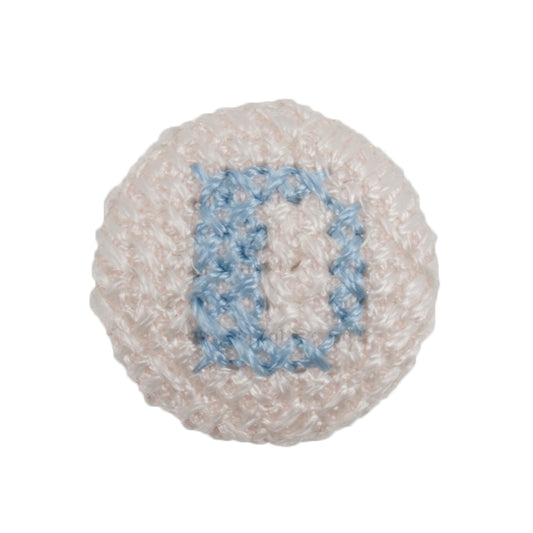 Round white fabric button with a light blue cross stitch letter D