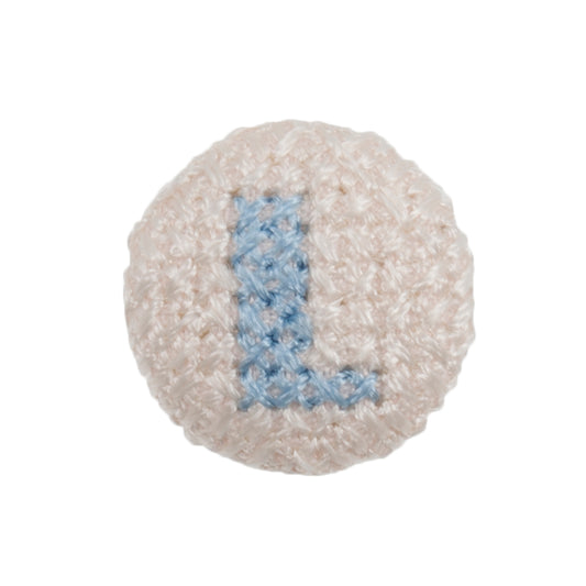 White fabric-covered button with a light blue cross-stitched letter L