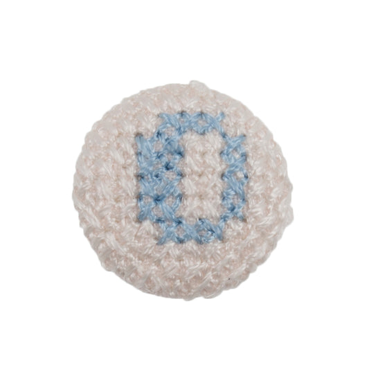 White fabric-covered button with a light blue cross-stitched letter O