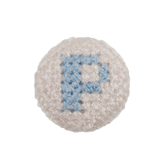 White fabric-covered button with a light blue cross-stitched letter P