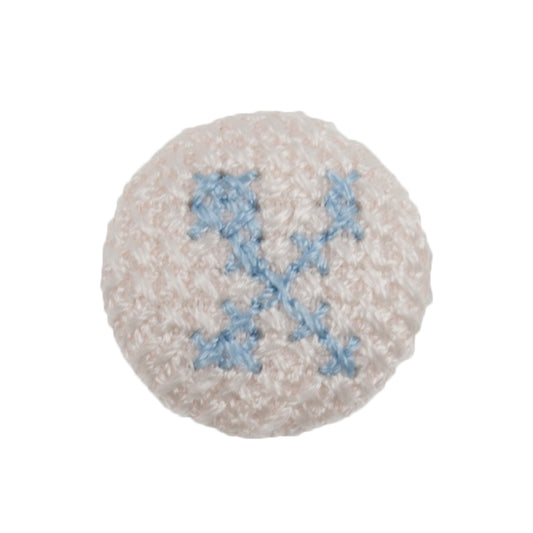 White fabric-covered button with a light blue cross-stitched letter X