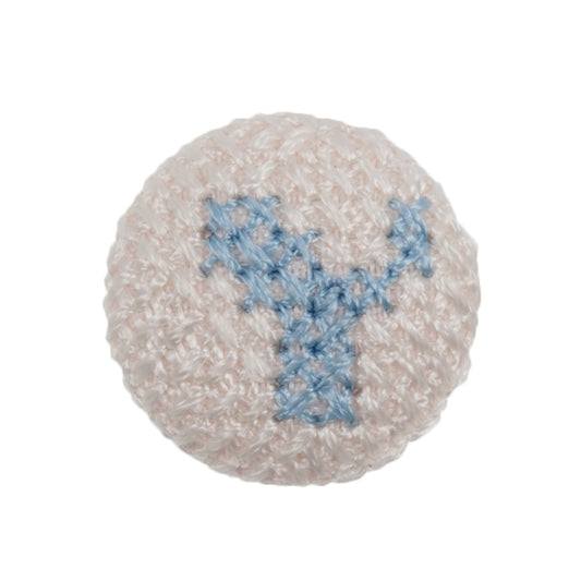 White fabric-covered button with a light blue cross-stitched letter Y