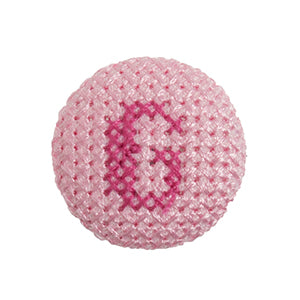 Pink fabric-covered button with a darker pink cross-stitched letter G