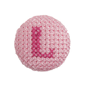 Pink fabric-covered button with a darker pink cross-stitched letter L