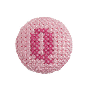 Pink fabric-covered button with a darker pink cross-stitched letter Q