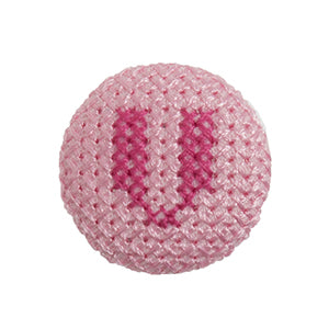 Pink fabric-covered button with a darker pink cross-stitched letter V