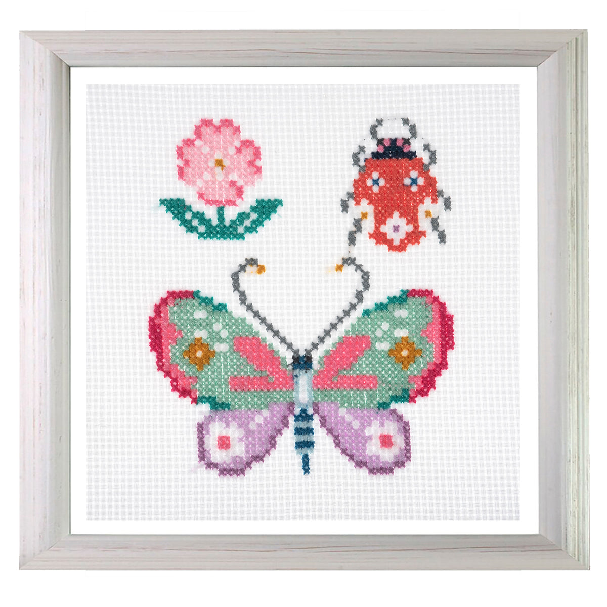 Trimits mini cross stitch kit showing a butterfly and a little bug