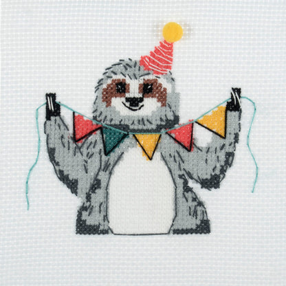 Trimits mini cross stitch kit showing a smiling sloth