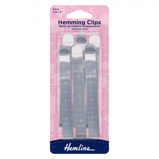 Six Hemline stainless steel hemming clips with engraved measurement markings