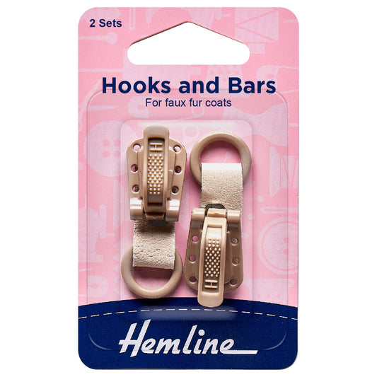Two beige Hemline faux fur coat hook and bar sets on card