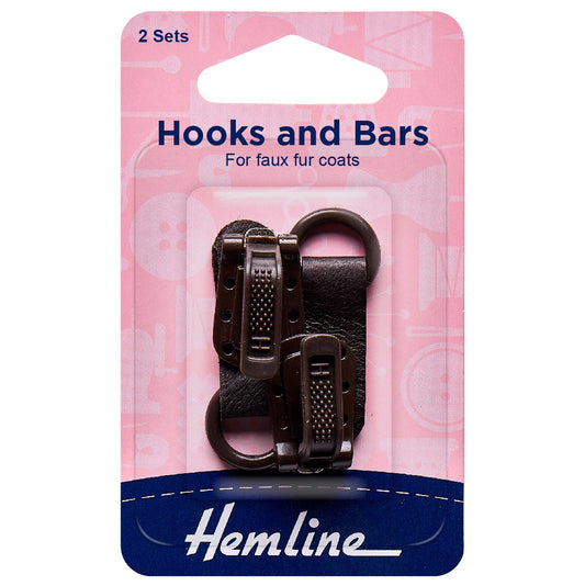 Two dark brown Hemline faux fur coat hook and bar sets on card