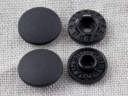 Tub of black Hemline 13mm tool-less plastic snaps
