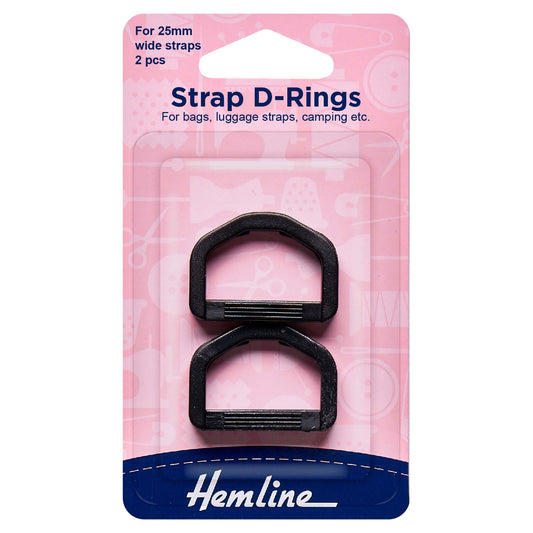 Two black strap D rings on a Hemline card