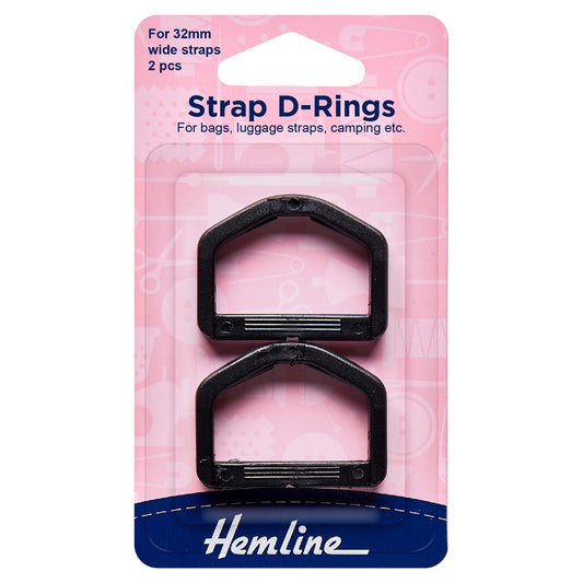 Two black strap D rings on a Hemline card