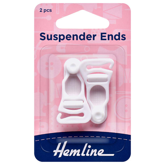 A pair of white suspender ends on a Hemline card