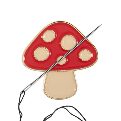 Red and cream enamel toadstool needle minder