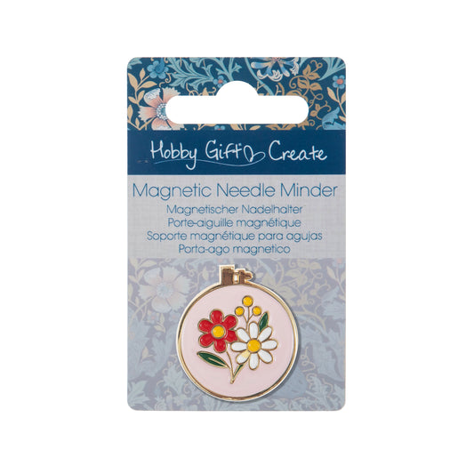 Round enamel magnetic needle minder with a colourful enamel embroidery hoop design with bright floral detailing