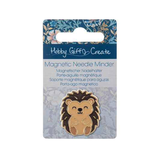 Round enamel magnetic needle minder with an enamel hedgehog design in warm brown and cream