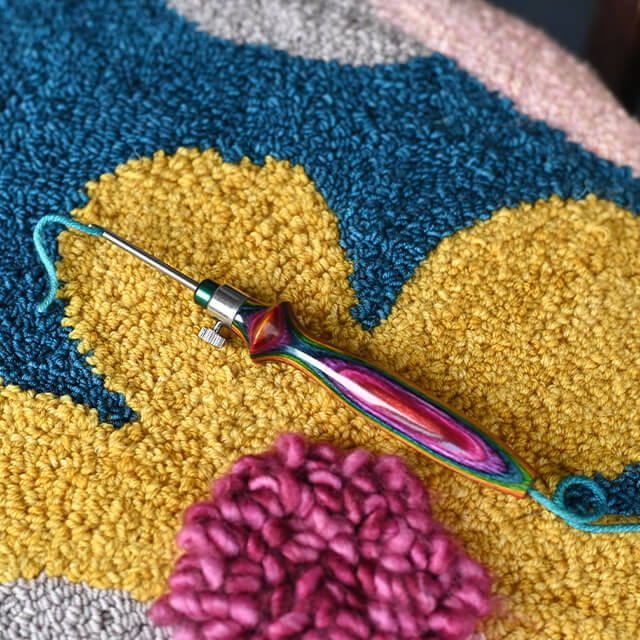 KnitPro Vibrant punch needle set with wooden handle and needles in a blue denim case