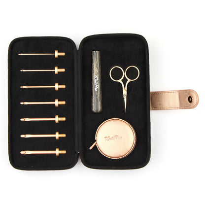 KnitPro Oasis starter crochet hook set with rose gold heads and grey onyx handle in a black faux suede case