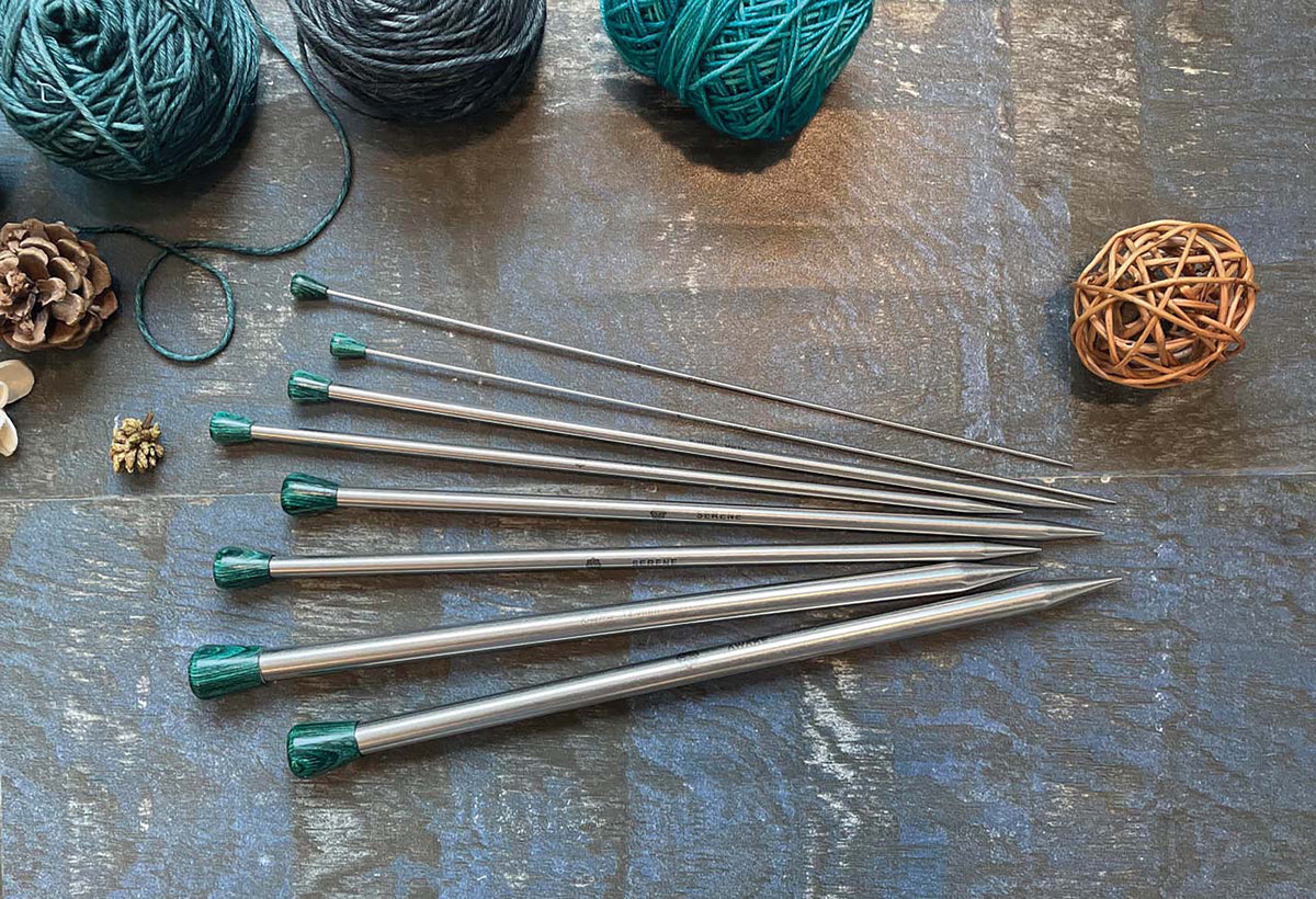 Pair of KnitPro Mindful 5mm stainless steel straight knitting needles with teal mandala end knobs